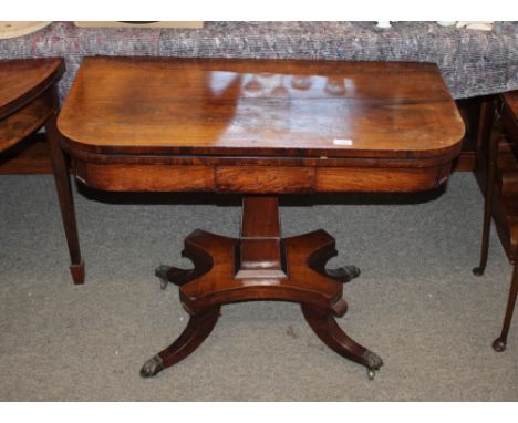 A 19th Century rosewood card table,&nbsp;the rectangular fold over swivel top raised on square tapered column and quatrefoil 