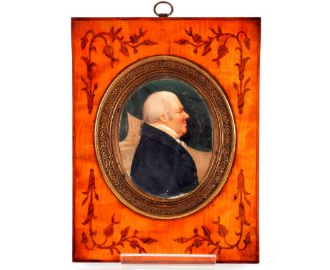 An 18th Century oval portrait miniature, of a gentleman in white stock and blue coat, the wooden frame with inlaid decoration
