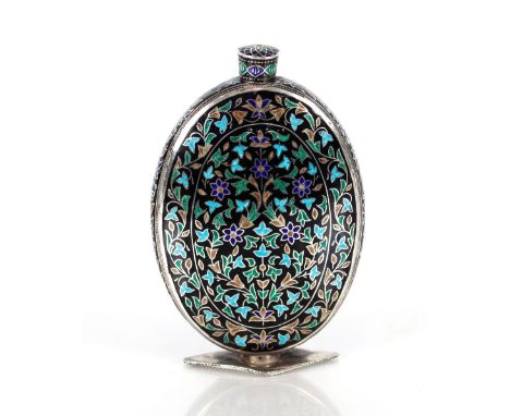 An early 20th Century metal Indo / Persian perfume flask,&nbsp;of flattened oval form with over coloured enamel floral design