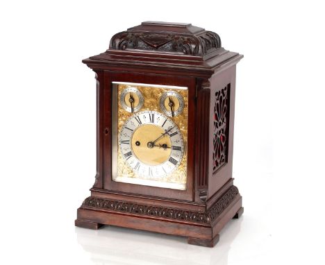 A late 19th / early 20th Century carved mahogany chiming bracket clock, brass chased dial with steel chapter ring, slow / fas
