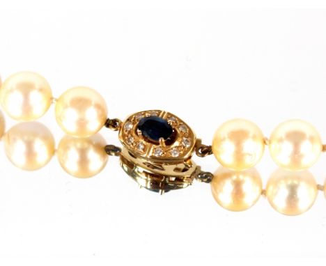 A well graded&nbsp;large pearl necklace consisting of 63 pearls,&nbsp;set to an 18ct gold sapphire and diamond clasp, 67cm lo