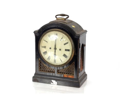 A Regency&nbsp;bracket clock,&nbsp;the domed case with brass carrying handle above pierced grills, circular Roman numeral dia