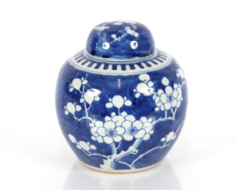 A Chinese blue and white ginger jar and cover, painted in the prunus pattern with underglaze double ring, and four character 