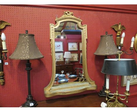 A gilt painted wall mirror of classical design with shelf base 