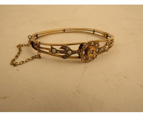 A Victorian bangle set with seed pearls and central rose cut diamond
