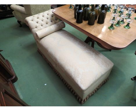 A deep button scroll back day bed with rising seat over castors       