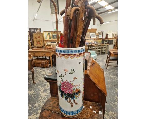 A quantity of various walking sticks in an oriental ceramic stand. 