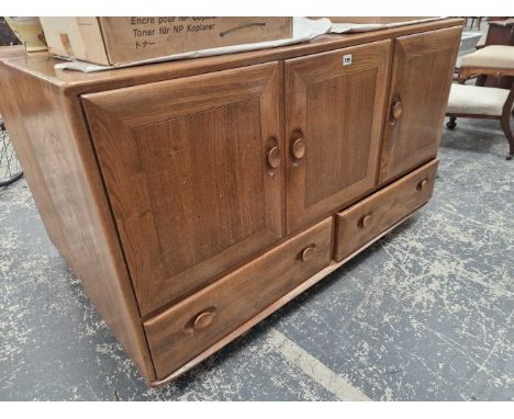 An Ercol elm small sideboard with three doors over drawers 129 x 43 x 77 cm high