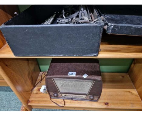 A vintage Bakelite radio and a portable typewriter.