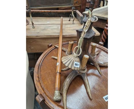 A walking stick and an antler form light fitting.
