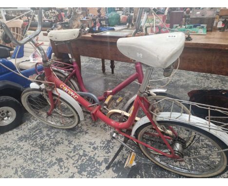 Two vintage folding shopper bicycles. 