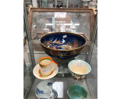 A large Carltonware bowl, a Clarice Cliff bizarre coffee can and saucer and a Clarice Cliff small vase.