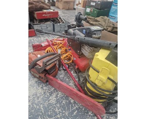 A Clarke compressor, a chainsaw, pressure washer and a jack. 