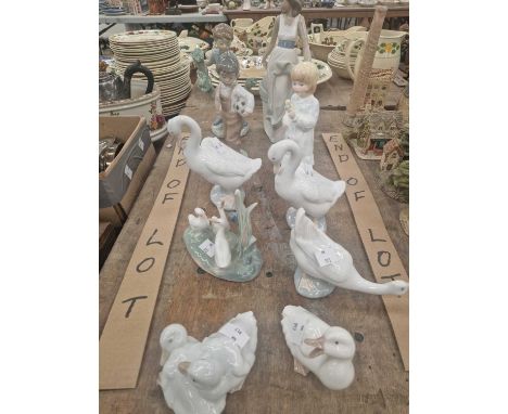 A collection of Nao figurines and one by Coalport. 
