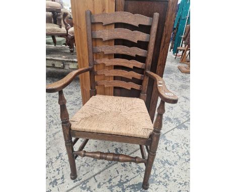 A large ladder back rush seat armchair.