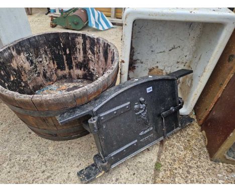 an antique cast iron stove door, together with a barrel form planter and a belfast sink