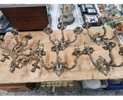 A set of four ormolu three light wall brackets together with another pair