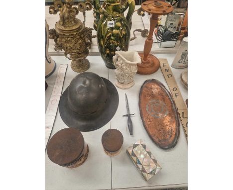 Two saltglaze pharmacy jars, a WWII tin hat, an arts and crafts copper dish, a Chinese soapstone carved jar, a mother of pear