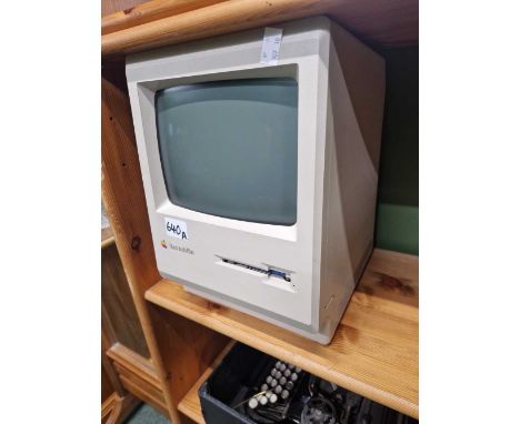 A vintage Macintosh Plus computer.