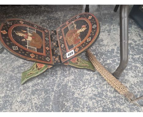 An Eastern book stand and a whip.