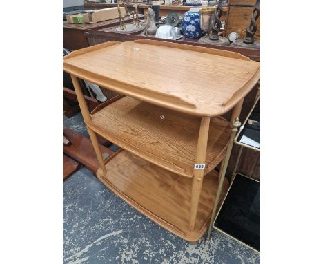 An Ercol pale elm three tier trolly