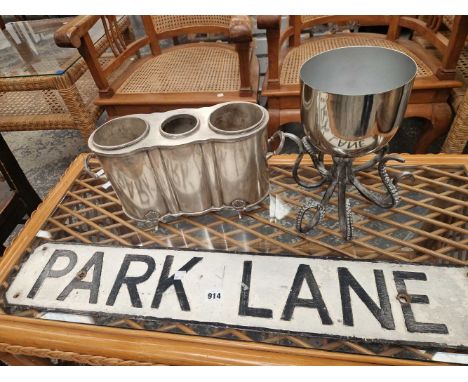 A plated wine cooler, a vintage Park Lane street sign, and an octopus jardiniere.