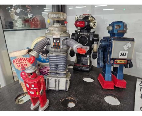 Four toy robots together with a Batman talking alarm clock