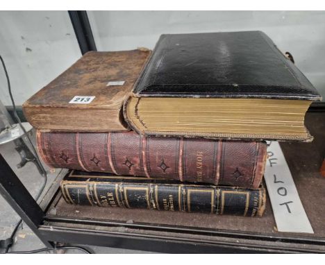Three family bibles together with an album partially filled with Victorian portrait photographs