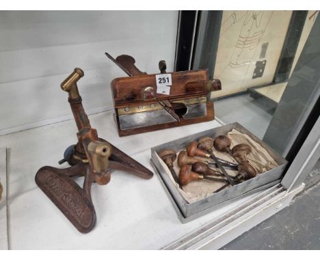 Nine wood engraving tools, a plane and a grass sprinkler