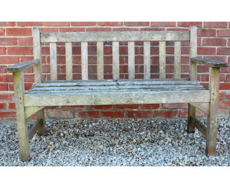 A SMALL TEAK GARDEN BENCH with slatted back and seat, 128cm wide 