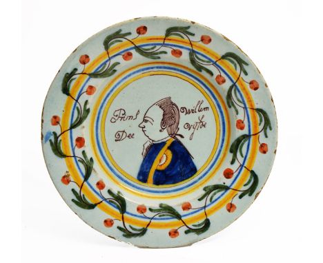AN 18TH CENTURY DUTCH TIN GLAZED DELFTWARE POLYCHROME PLATE decorated with a profile portrait of Prince William III, set with
