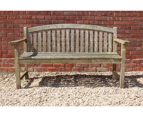 AN OLD TEAK GARDEN BENCH with slatted back and seat, 159.5cm wide 