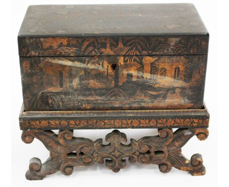 A REGENCY BLACK LACQUERED TEA CADDY of rectangular form, decorated with chinoiserie scenes in gold, the lid opening to reveal