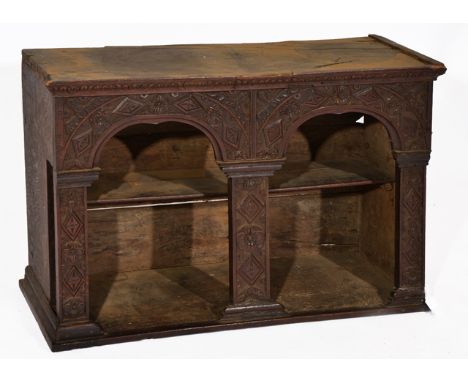 A 17TH CENTURY AND LATER OAK WALL SHELF with a twin arch front and carved geometric decoration, 86cm wide