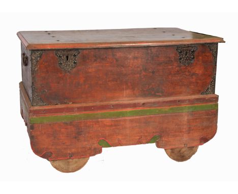 AN EASTERN POLYCHROME DECORATED COFFER with bracket feet and wooden wheels, 142cm wide x 91cm high