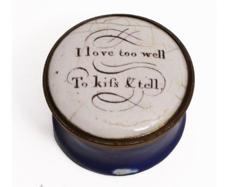 A GEORGE III CIRCULAR ENAMEL PATCH BOX with lid inscribed 'I Love Too Well To Kiss & Tell', with a blue ground base and crack