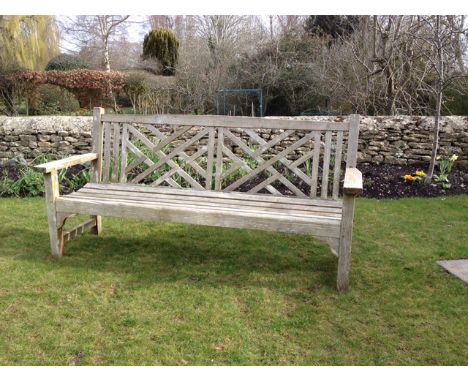 A TEAK GARDEN BENCH with slatted back and seat, 182.5cm long