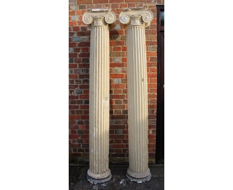A PAIR OF PLASTER IONIC ARCHITECTURAL COLUMNS with fluted shafts, each 234cm high
