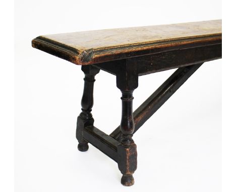 AN ANTIQUE OAK BENCH or form, with turned legs and of pegged construction, 245cm long x 54.5cm high