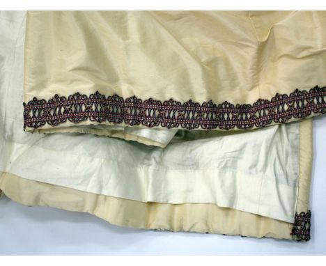 THREE PAIRS OF FRENCH IVORY SILK INTERLINED CURTAINS, the bottoms fringed with French braid, each approximately 275cm long