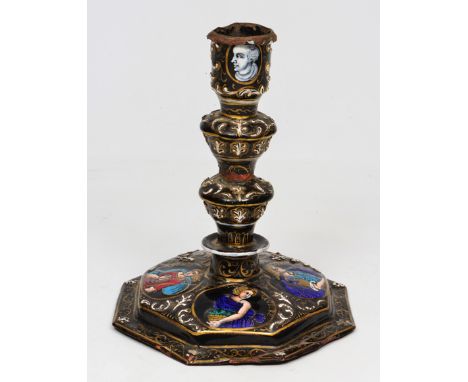 AN ANTIQUE LIMOGES ENAMEL CANDLESTICK OF 17TH CENTURY DESIGN with a flared candle holder, knopped stem, black ground painted 