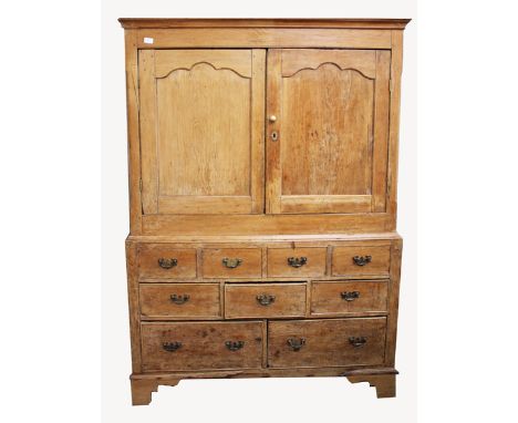 AN EARLY TO MID 19TH CENTURY PINE PRESS CUPBOARD with twin shaped panel doors over four dummy short drawers and five further 
