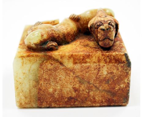 A CHINESE HARDSTONE SEAL surmounted by a dragon with four character mark to the underside, 7.5cm wide by 6cm tall 