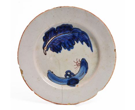 AN 18TH CENTURY DELFTWARE PLATE decorated with an abstract design of a leaf and rockwork, 19.2cm diameter (AF)