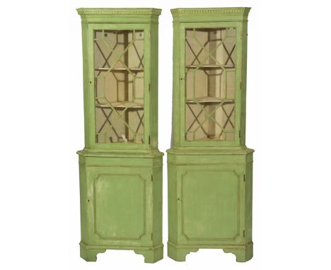A PAIR OF GEORGIAN STYLE GREEN PAINTED FLOOR STANDING CORNER CUPBOARDS with astragal glazed doors above cupboards beneath and