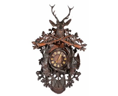 A LARGE AND IMPRESSIVE MID TO LATE 19TH CENTURY BLACK FOREST CARVED PINE CUCKOO CLOCK with stags head, rifle and oak leaf cre