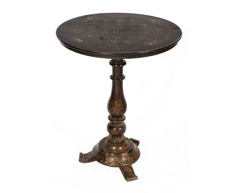 A VICTORIAN CIRCULAR TILT TOP BLACK LACQUERED GAMES TABLE with mother of pearl inlay to the chess board and with a further pa