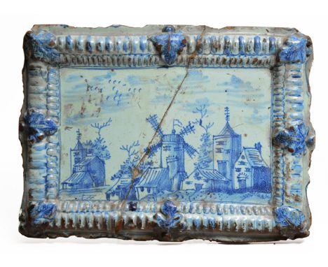 A LATE 18TH/EARLY 19TH CENTURY DUTCH DELFTWARE MOULDED RECTANGULAR PLAQUE depicting a town scene within a gadrooned and leaf 