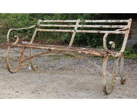 A LATE 19TH CENTURY WHITE PAINTED WROUGHT IRON GARDEN BENCH with slatted back and seat and scrolling ends, 153cm wide