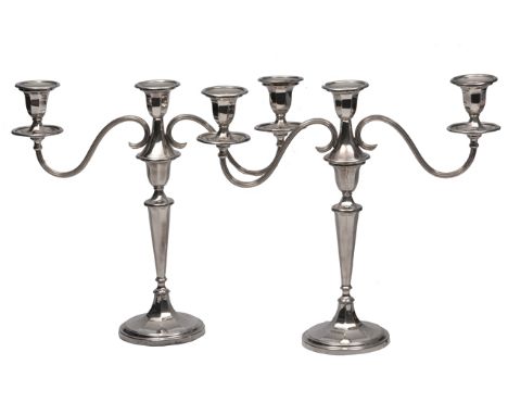 A PAIR OF MID 20TH CENTURY SILVER THREE LIGHT CANDELABRA, each with twin scrolling reeded arms and on tapering hexagonal supp